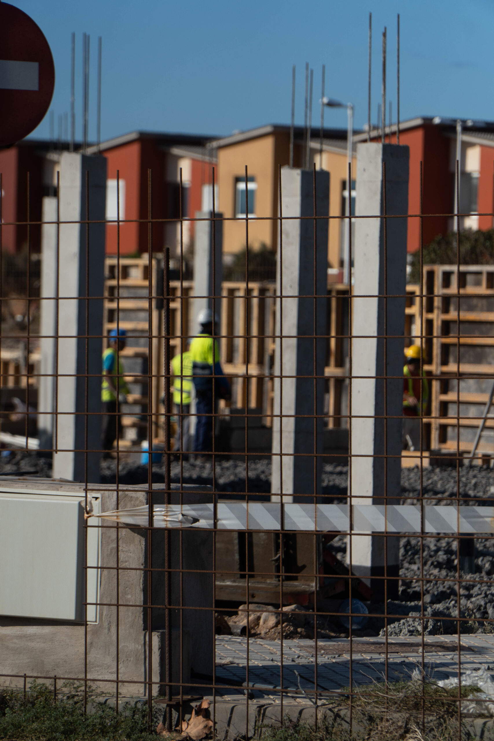A vertical shot of a construction site with a male Caucasian worker in Spain
